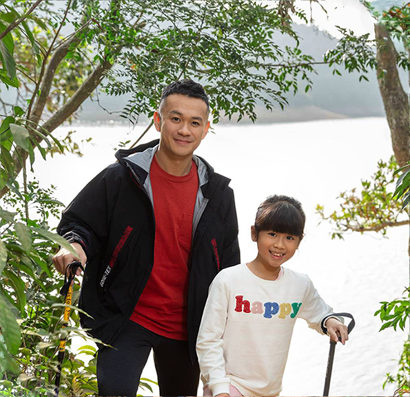 Father and daughter hiking at the countryside